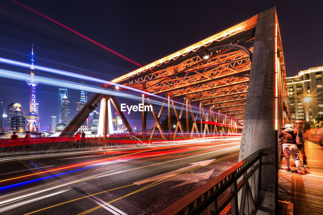 Illuminated bridge at night