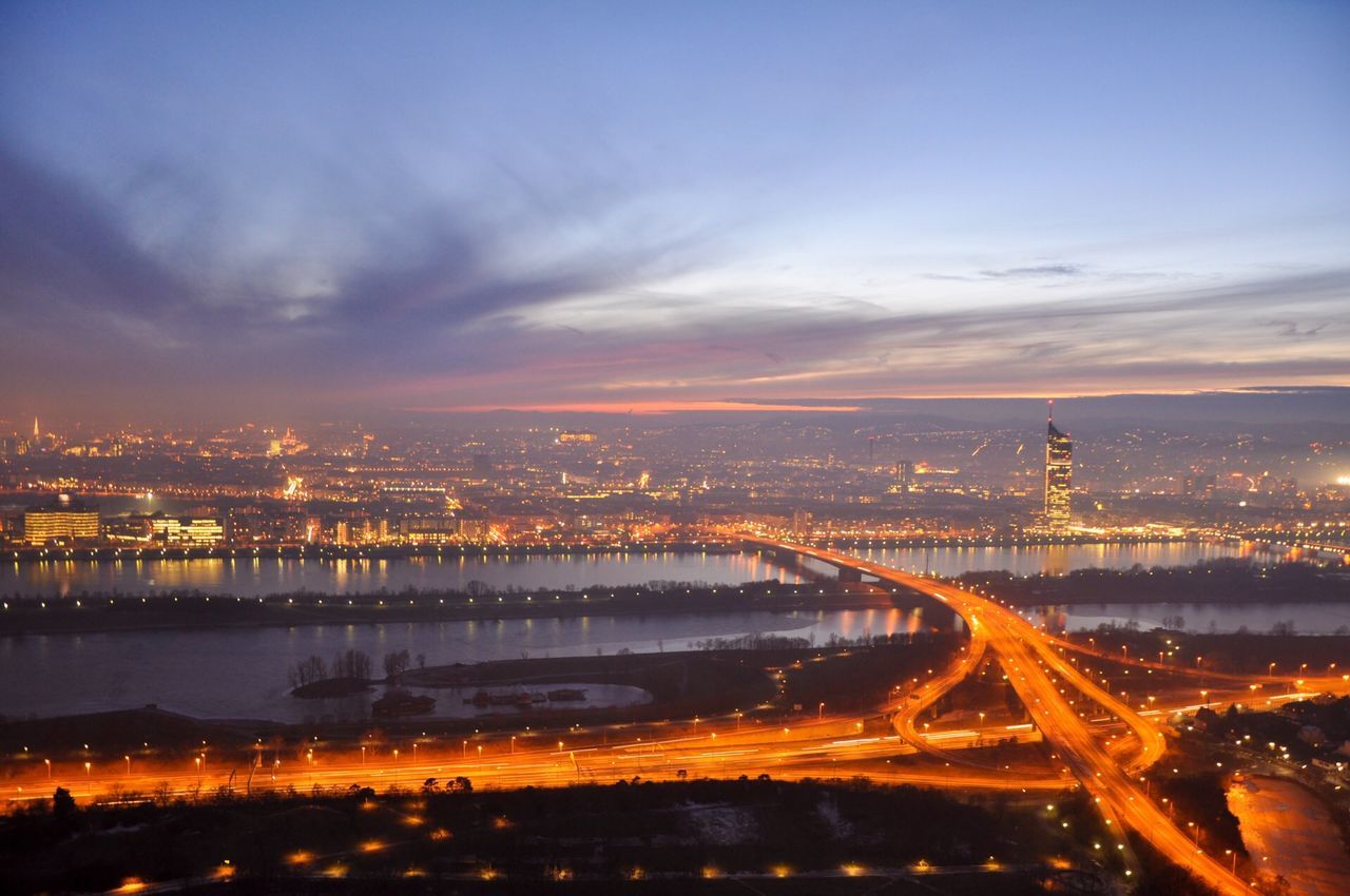 Aerial view of city lit up at sunset