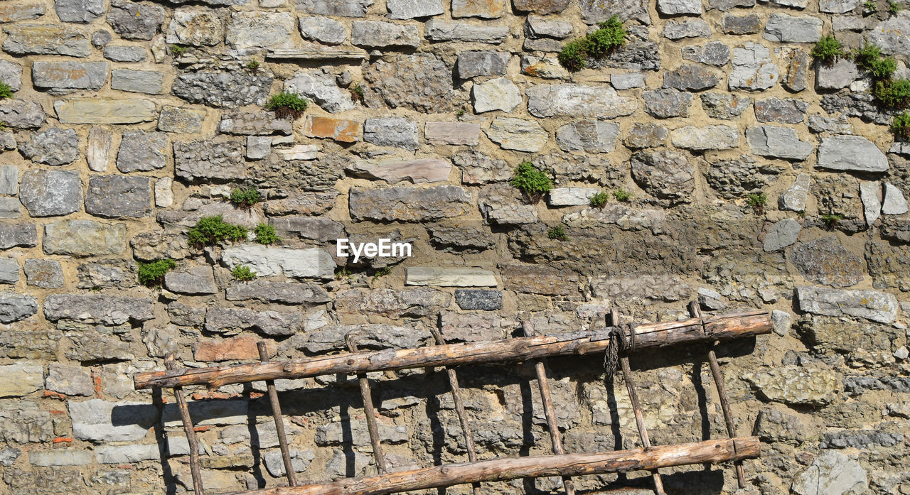 BRICK WALL WITH BRICK WALL IN BACKGROUND