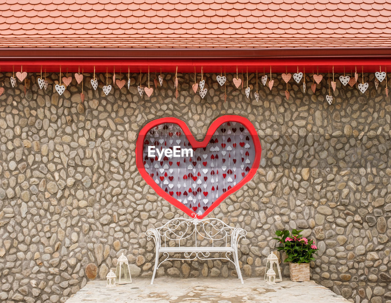 Love scene for taking pictures with an iron bench and a frame with a red heart in the center