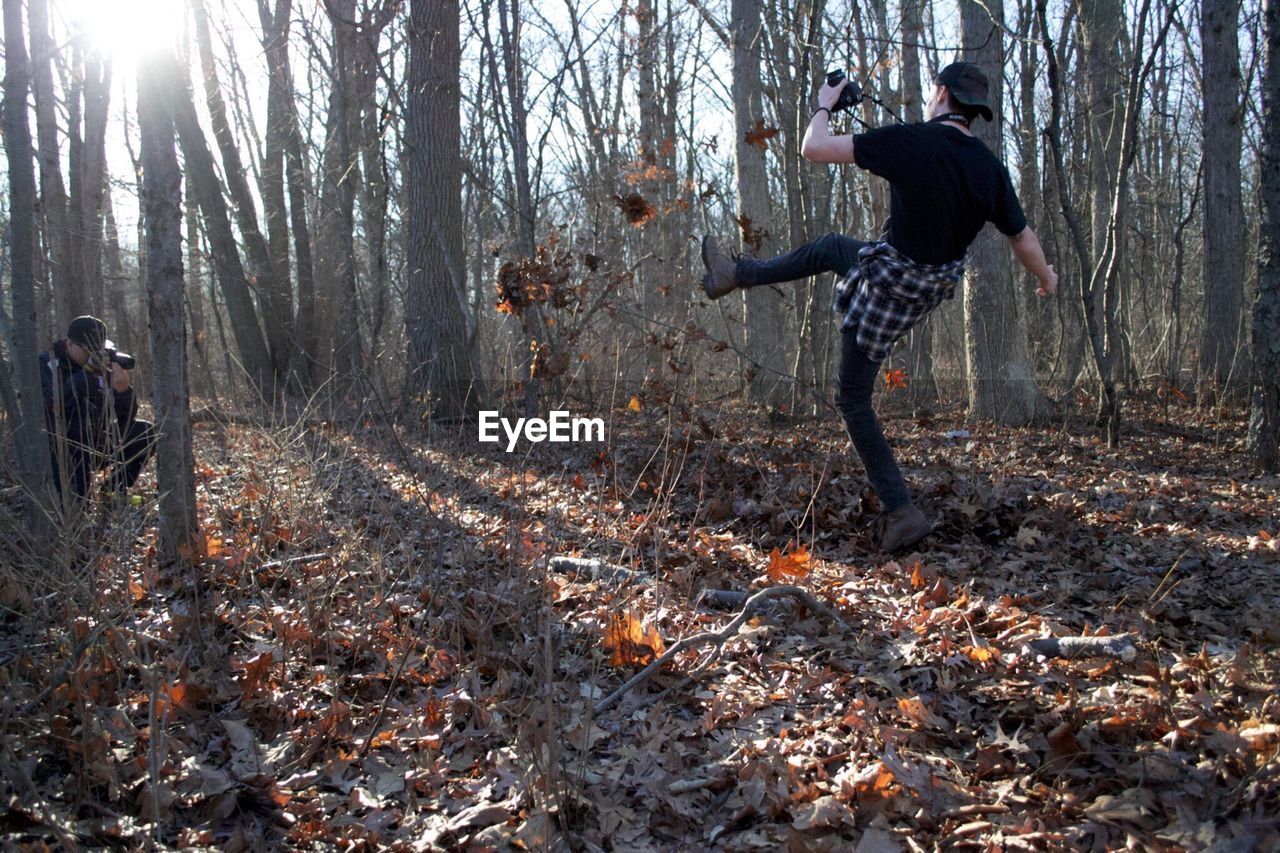 FULL LENGTH OF MAN IN FOREST DURING WINTER