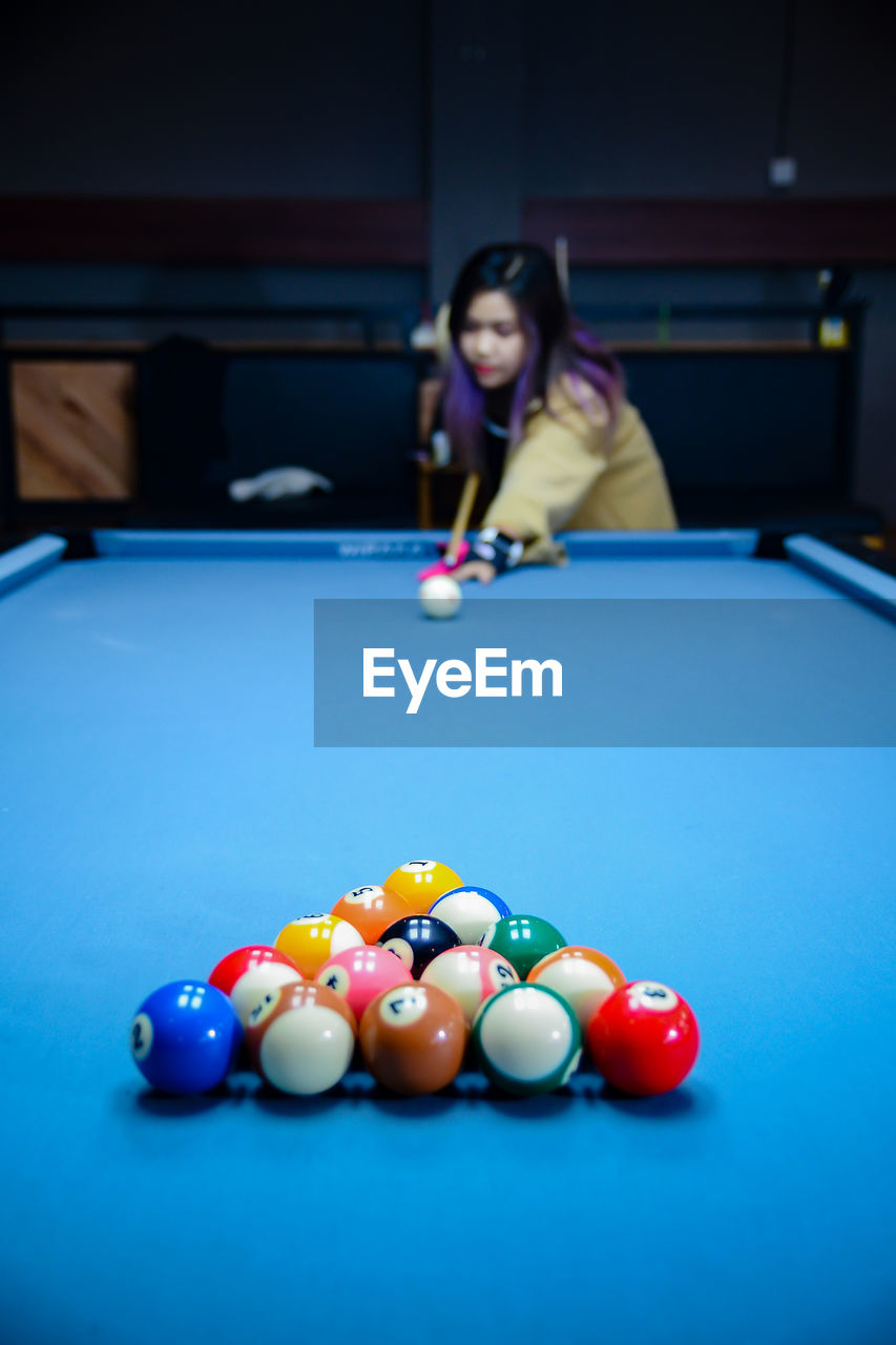 portrait of woman playing pool at home