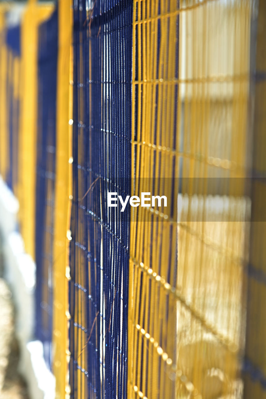 yellow, metal, window covering, selective focus, no people, close-up, industry, business, architecture, indoors, cage