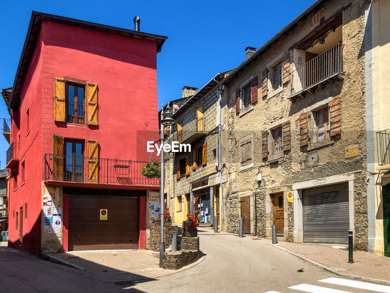 Street amidst buildings in town against clear sky, in llívia. 