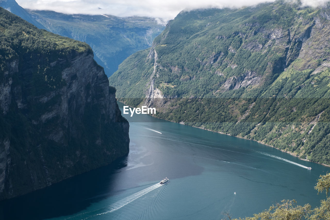 Scenic view of river amidst mountains