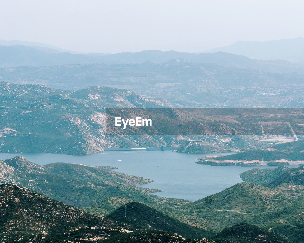 Aerial view of city by sea against sky