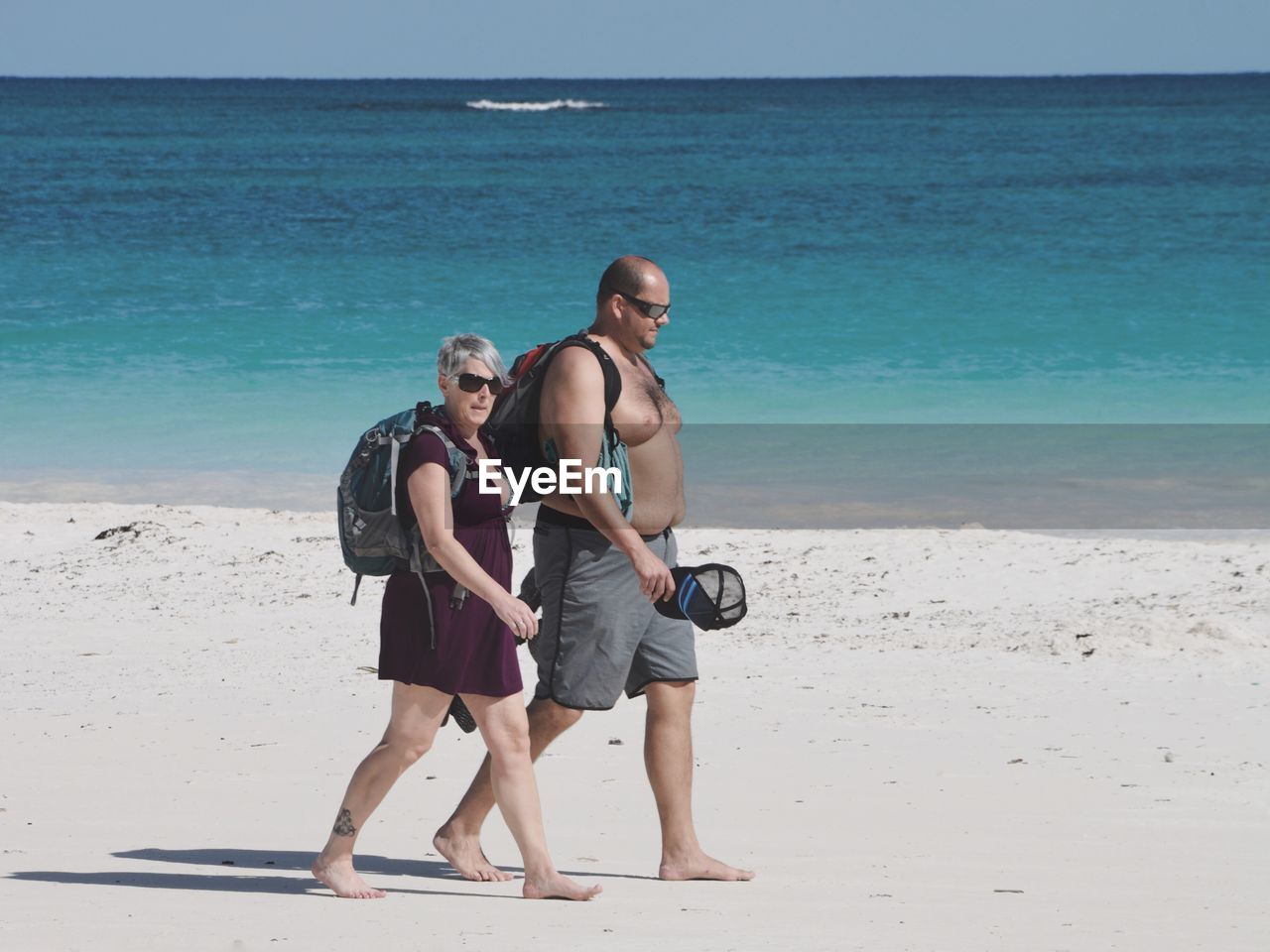 WOMAN STANDING ON BEACH