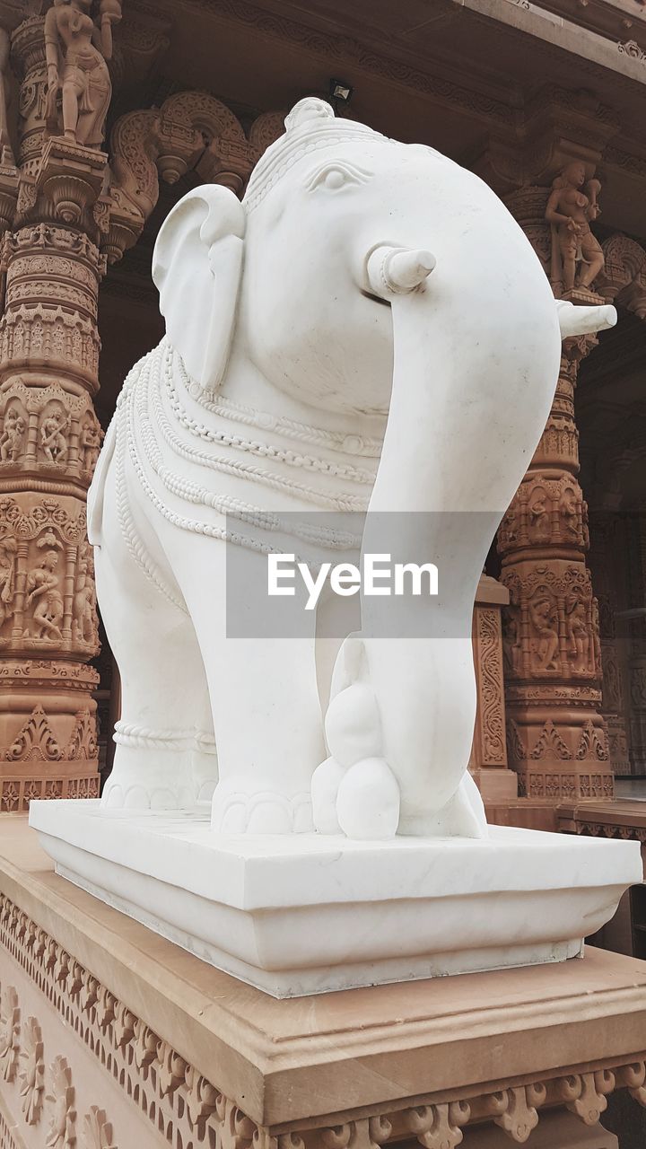 LOW ANGLE VIEW OF STATUE AT TEMPLE