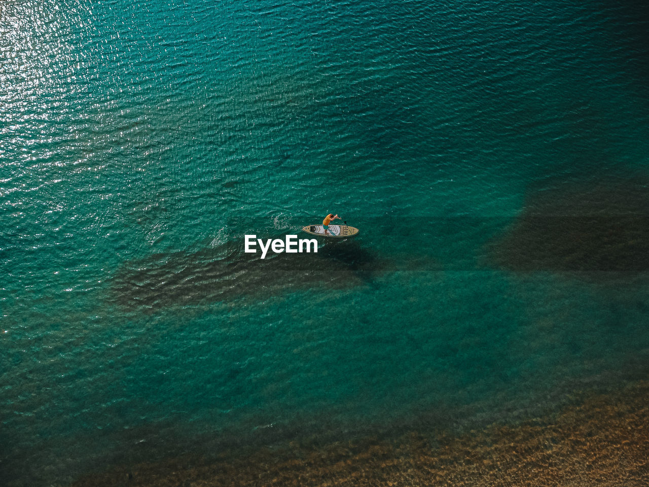 High angle view of people swimming in sea