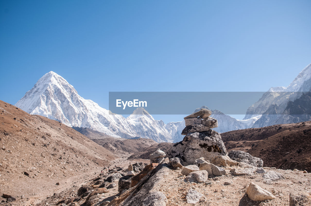 Scenic view of snowcapped mountains against clear blue sky