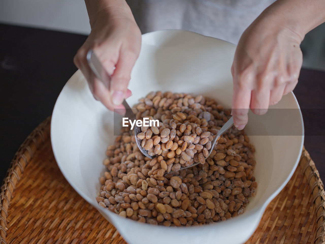 food and drink, food, hand, one person, meal, healthy eating, dish, indoors, freshness, wellbeing, bowl, breakfast, adult, produce, holding, cereal, women, preparing food, kitchen utensil, close-up, table, high angle view, lifestyles, seed, ingredient, baked