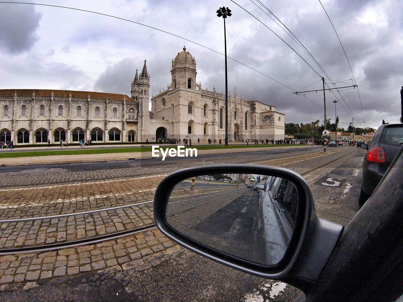 CAR ON ROAD AGAINST BUILDINGS