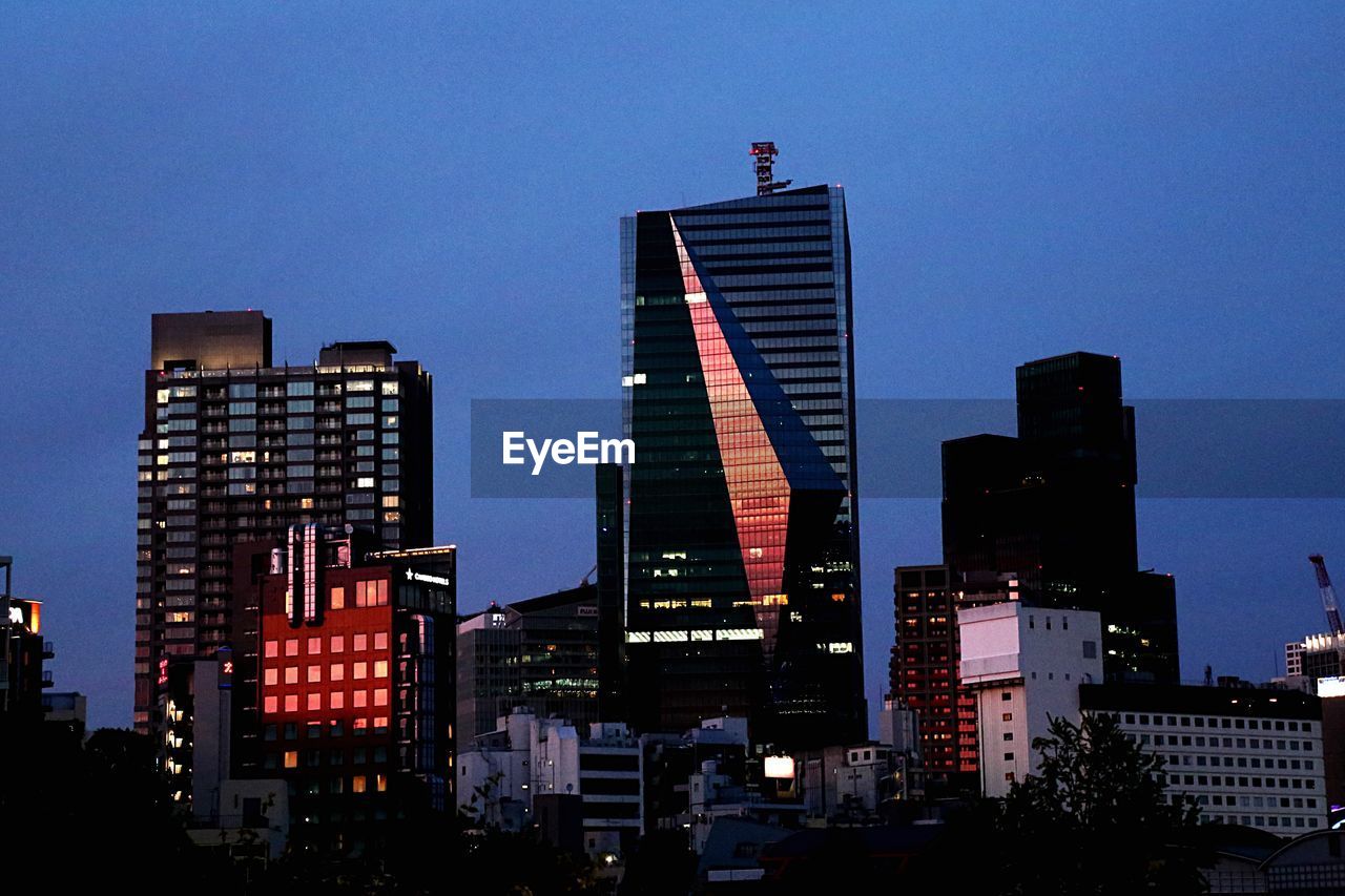 LOW ANGLE VIEW OF ILLUMINATED BUILDINGS AGAINST SKY