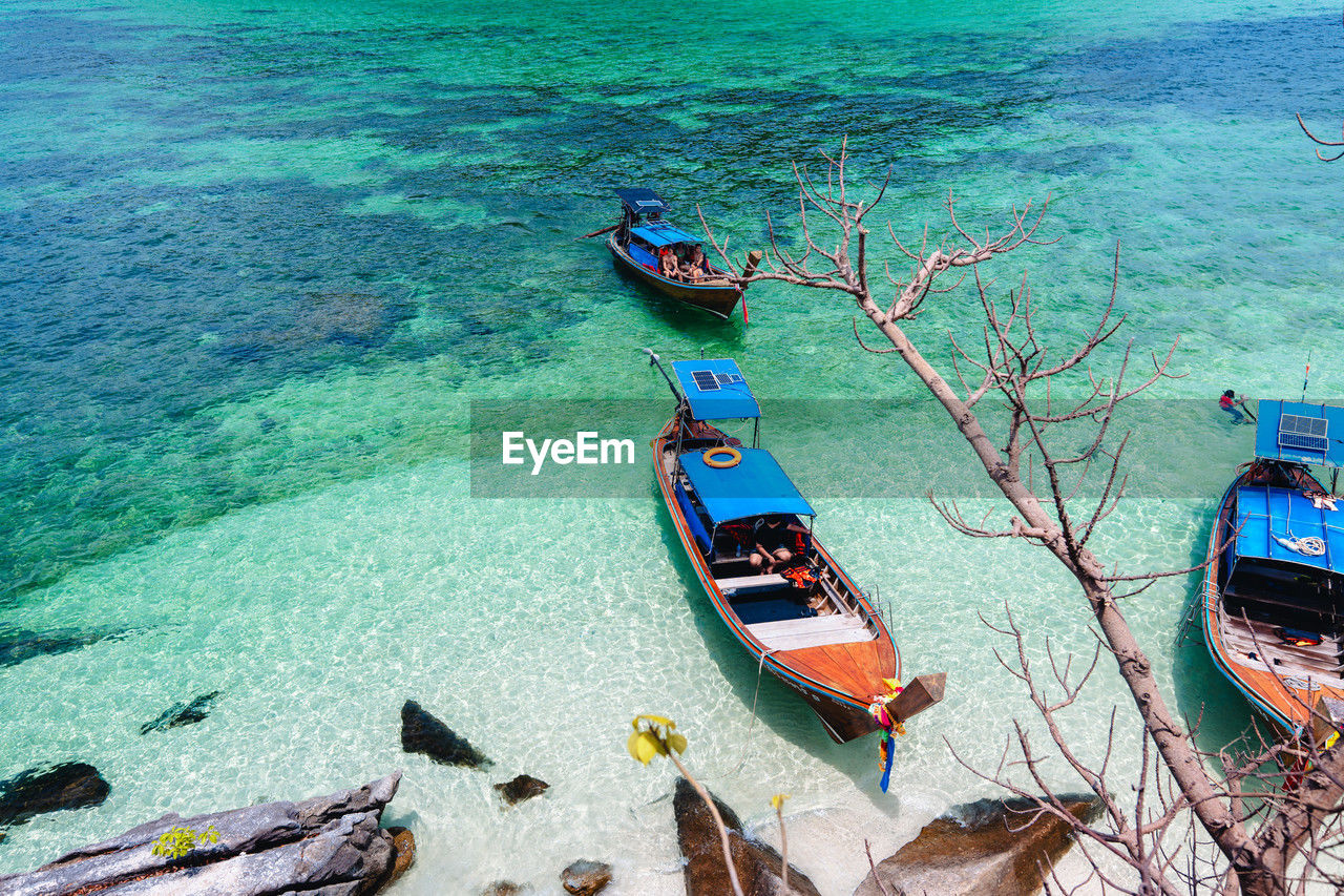 water, nautical vessel, transportation, high angle view, mode of transportation, vehicle, sea, nature, boat, day, moored, beauty in nature, scenics - nature, tranquility, travel, watercraft, outdoors, no people, boating, land, idyllic, tranquil scene, sunlight, beach, long-tail boat, ship, travel destinations, blue