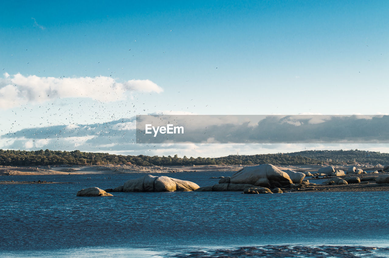 VIEW OF FROZEN SEA AGAINST SKY