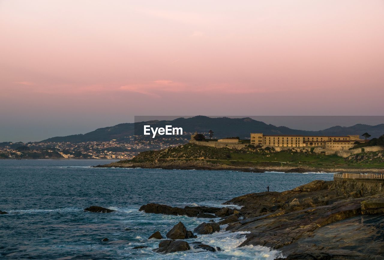 Sunset views in baiona with famous castle hotel and nigran in the background