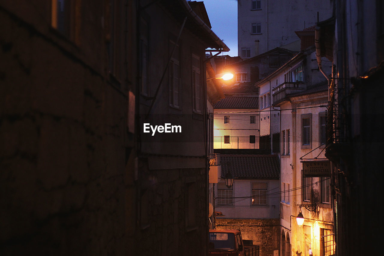 LOW ANGLE VIEW OF BUILDINGS AT NIGHT