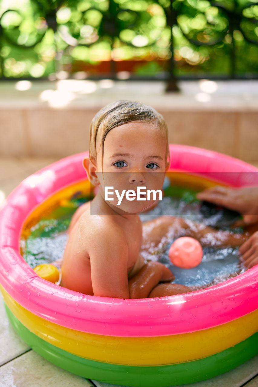 Portrait of cute boy in swimming pool