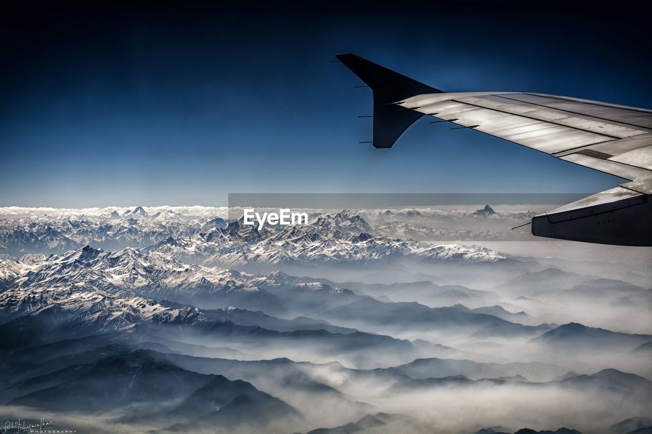 AERIAL VIEW OF CLOUDS OVER MOUNTAIN