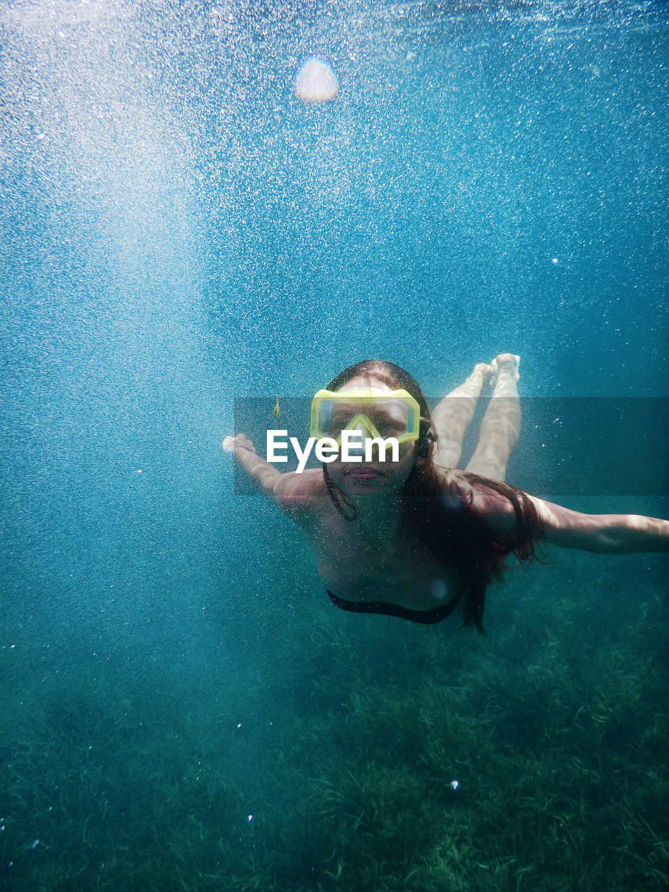 Young woman swimming in undersea