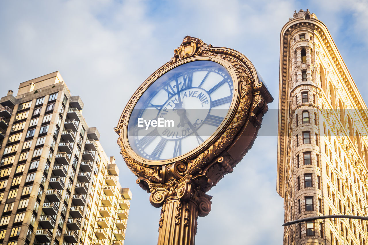 Low angle view of clock tower against sky in new york city 