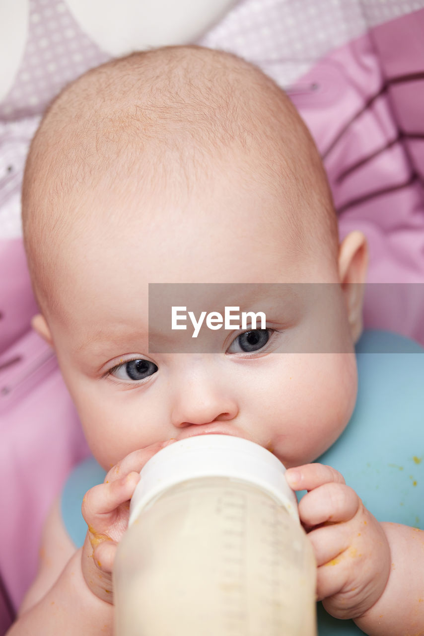 close-up of cute baby boy eating food at home