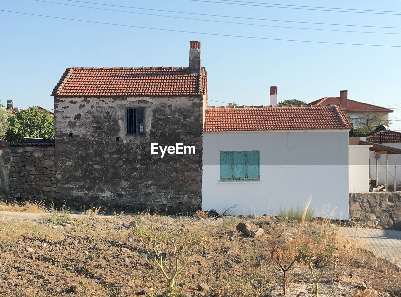 Exterior of houses in town against clear sky