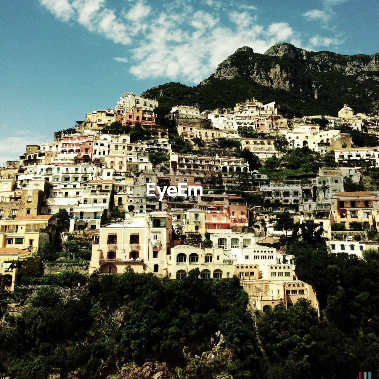 Low angle view of houses on mountain against sky