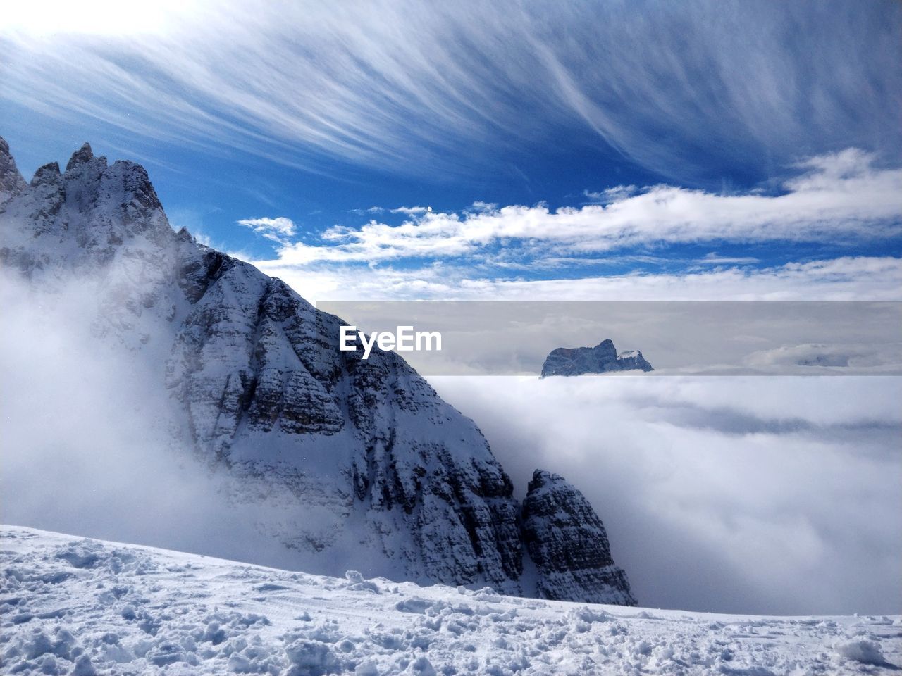 Scenic view of snowcapped mountains and cloudscape