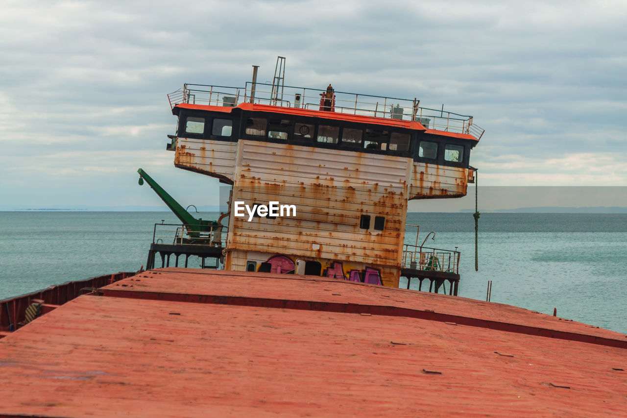 water, sea, ocean, sky, coast, architecture, pier, cloud, nature, horizon over water, tower, beach, built structure, horizon, land, vehicle, industry, shore, scenics - nature, day, outdoors, no people, building exterior, beauty in nature, ship, protection