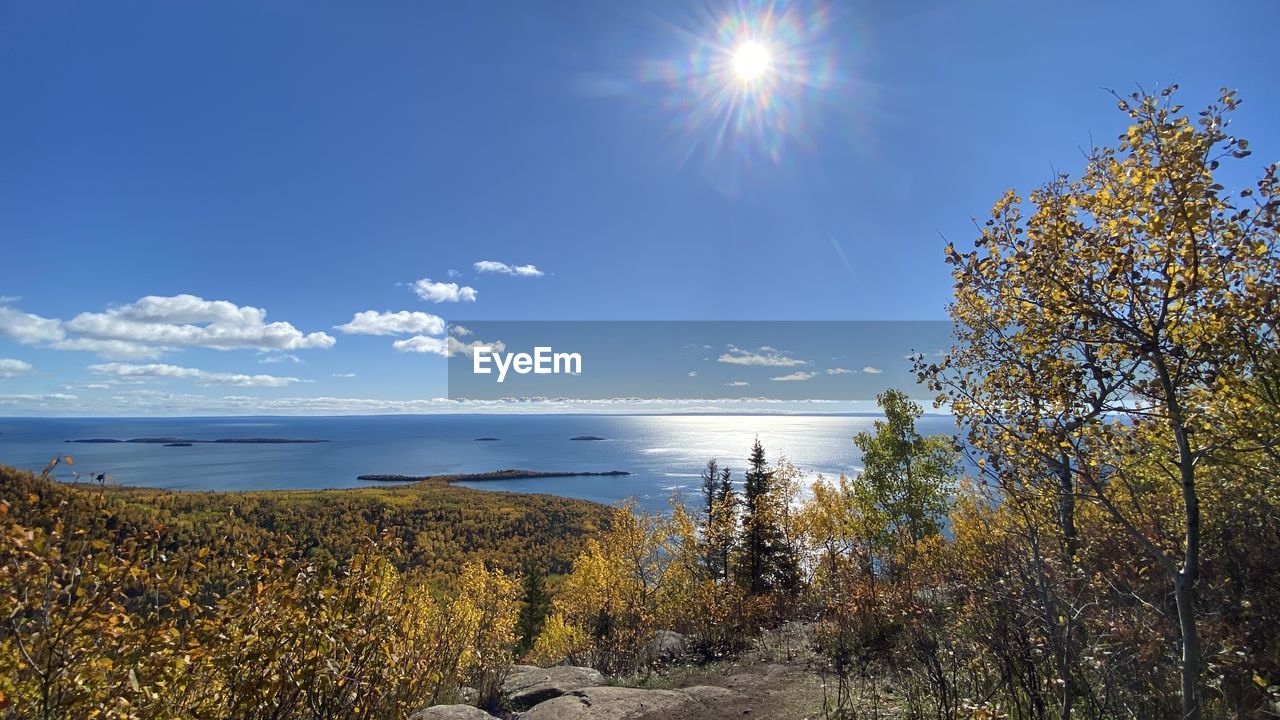 Scenic view of sea against sky on sunny day