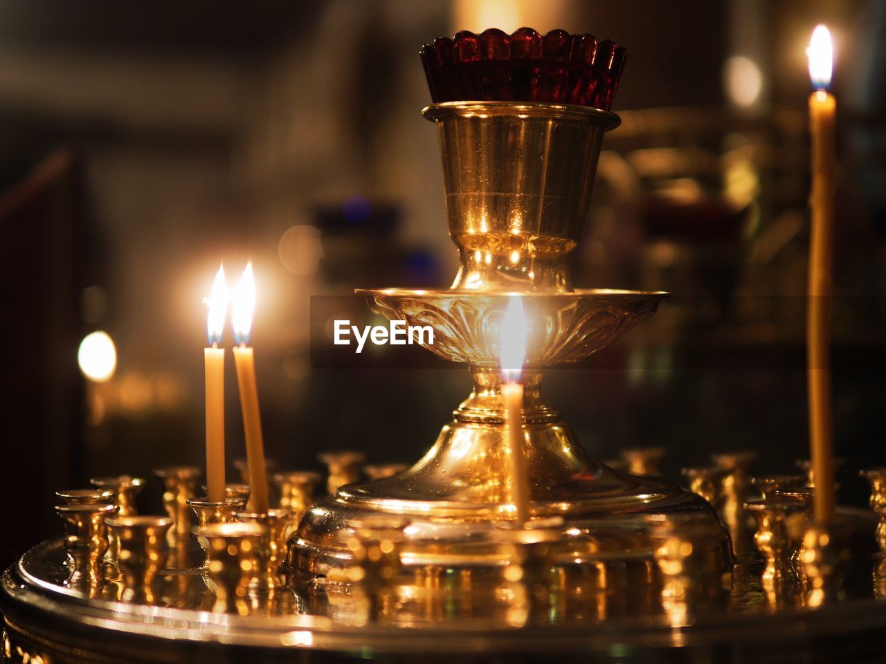 Close-up of illuminated candles on table