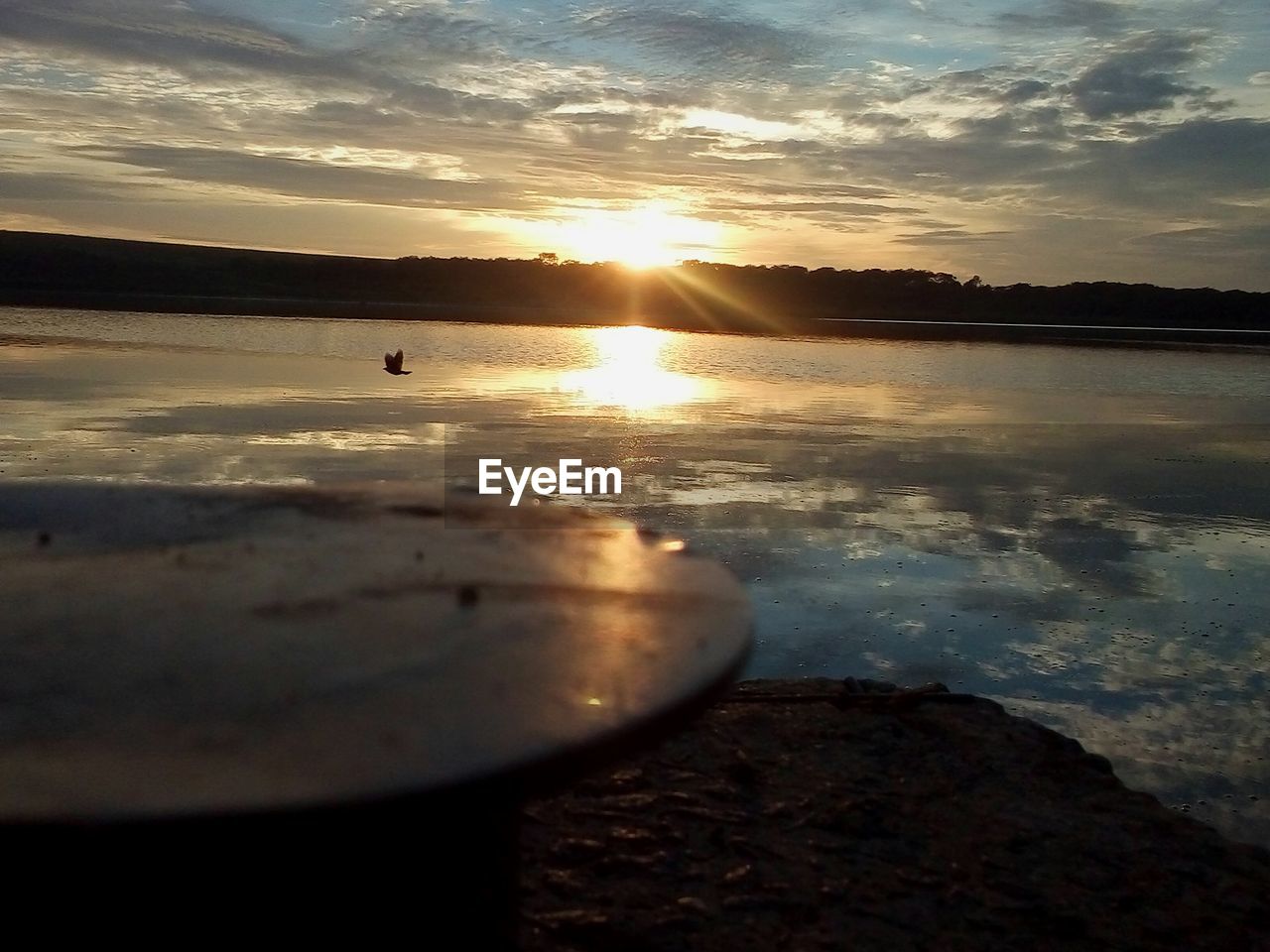 CLOSE-UP OF SEA AGAINST SUNSET SKY