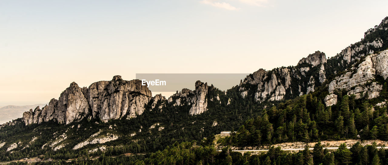 Panoramic view of rock formations on landscape against sky