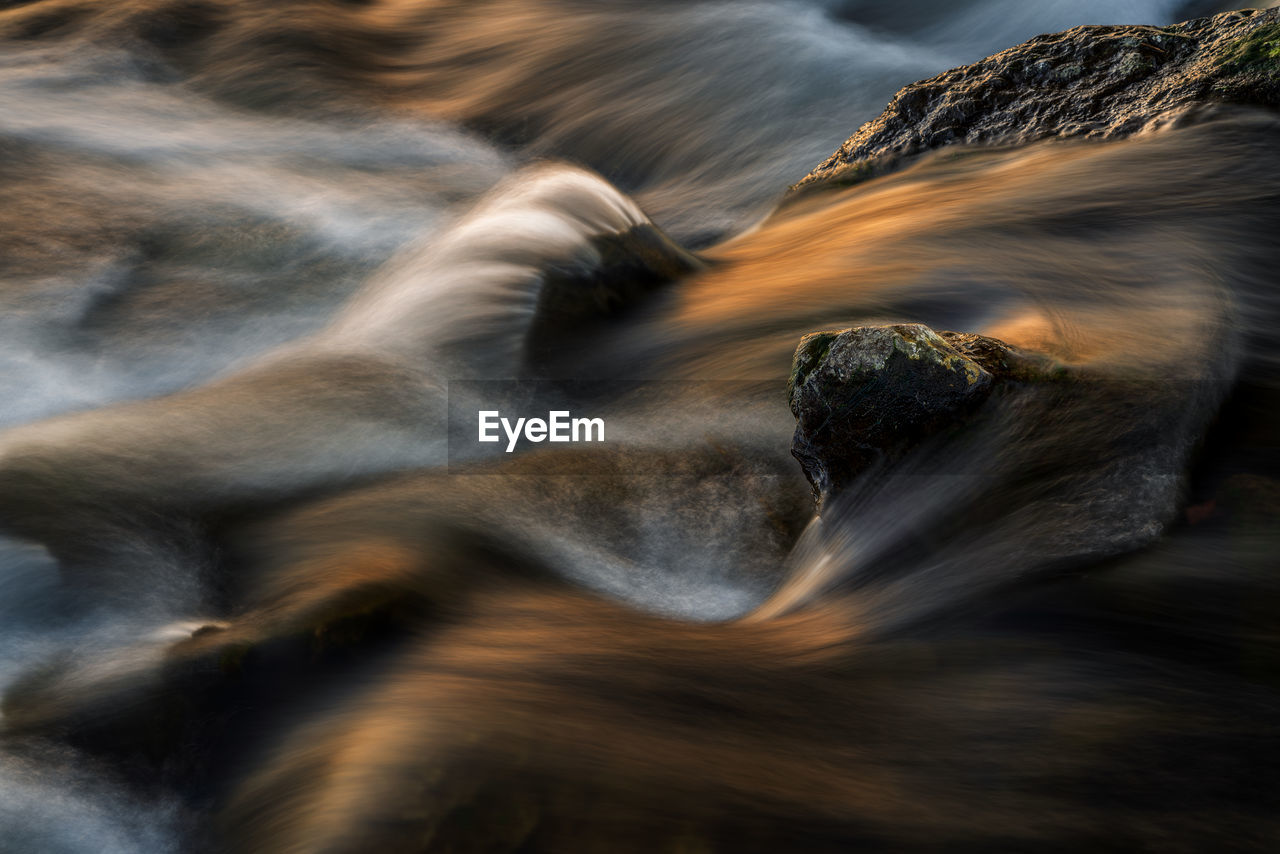 Blurred motion of water flowing through rocks