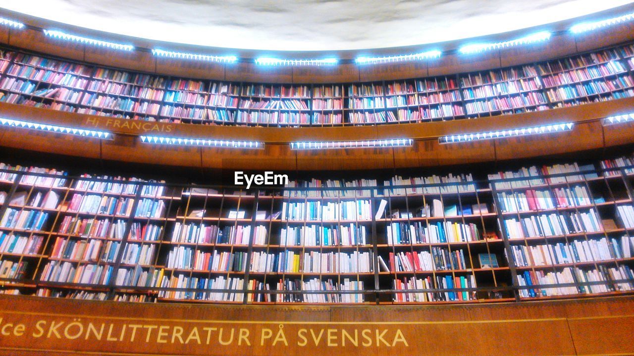 Low angle view of books in shelves at stockholm public library