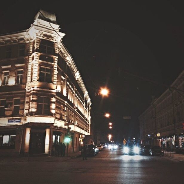 VIEW OF CITY STREET AT NIGHT