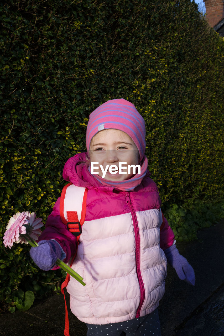 PORTRAIT OF SMILING GIRL WITH PINK HAT