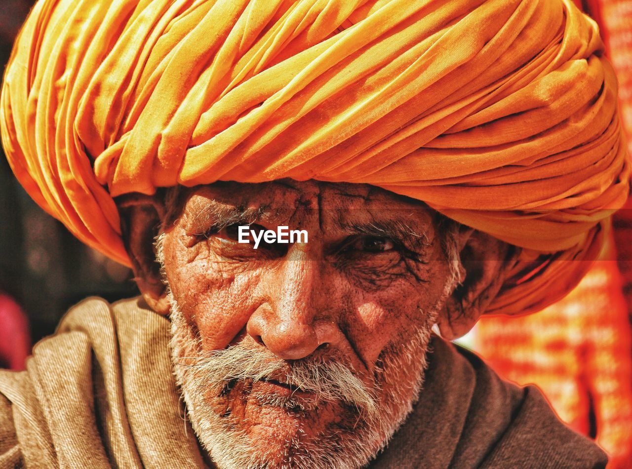 CLOSE-UP PORTRAIT OF A MAN WITH RED MASK