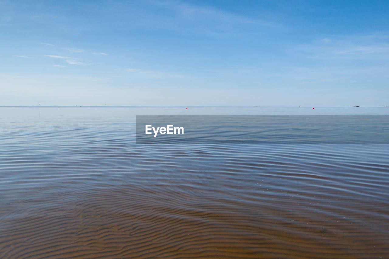 Scenic view of sea against blue sky