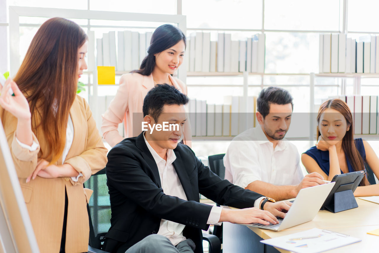 GROUP OF PEOPLE USING PHONE