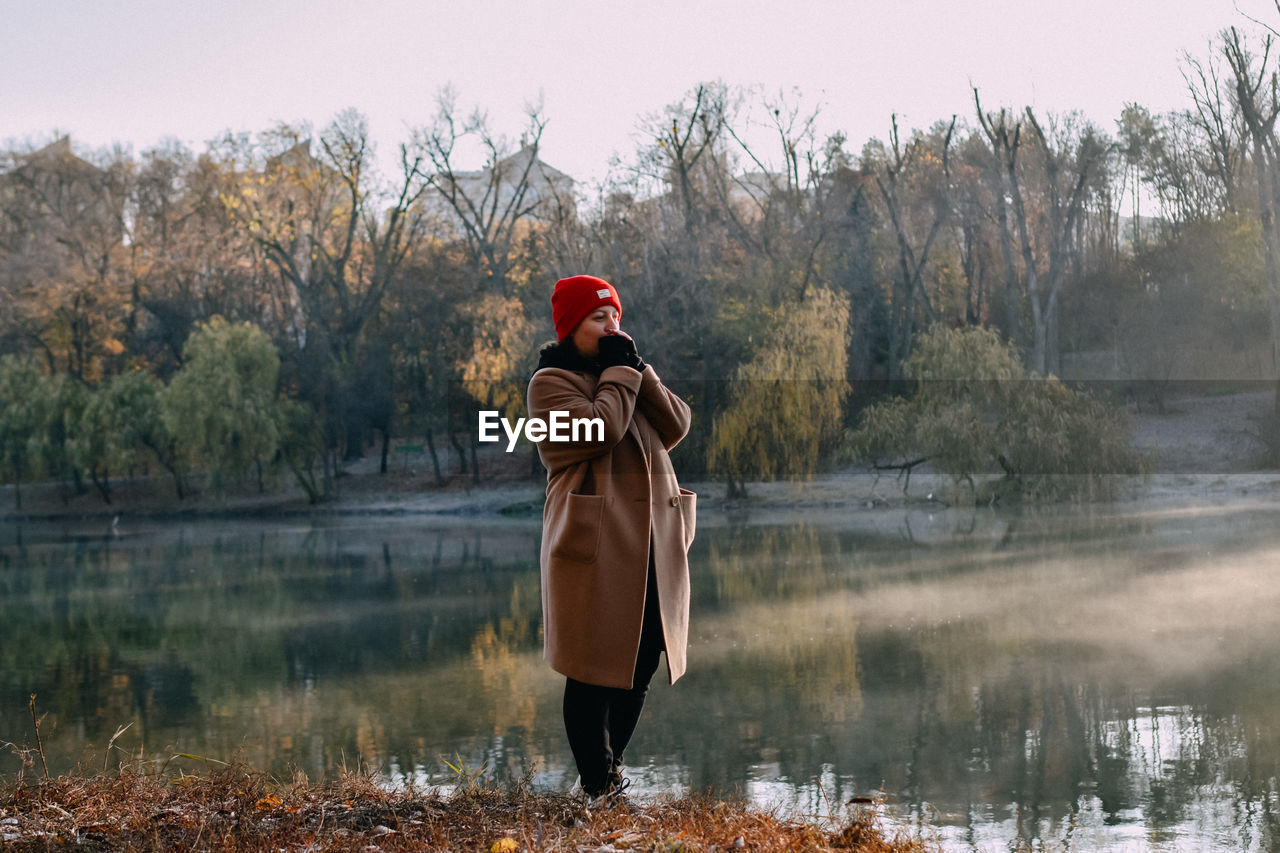 Rear view of man standing in lake