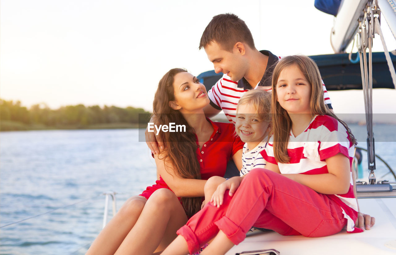 Happy family on boat during vacation