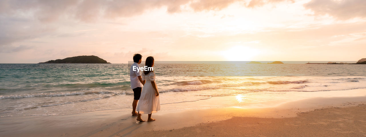 WOMAN AT BEACH DURING SUNSET