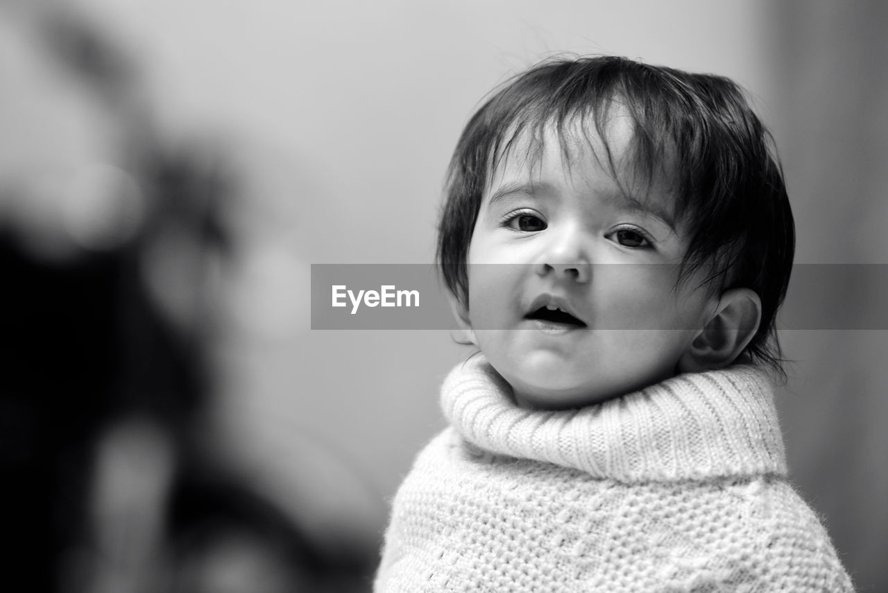 Close-up of cute baby girl wearing blanket