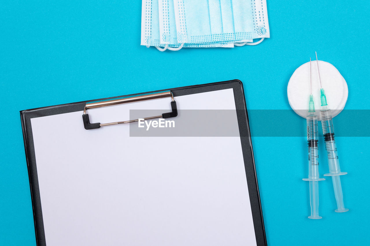 Vaccination or revaccination concept - two medical syringe on blue table