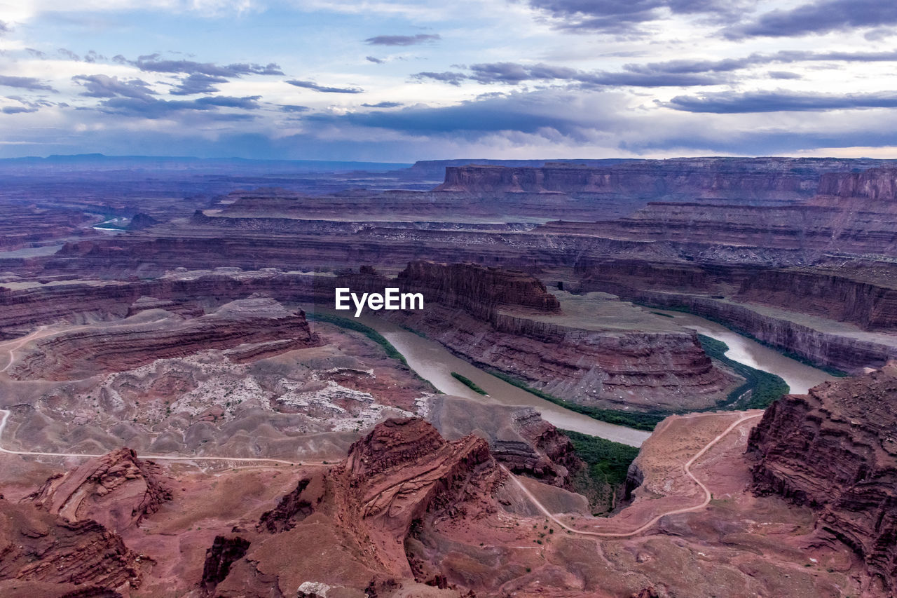 Aerial view of dramatic landscape against cloudy sky