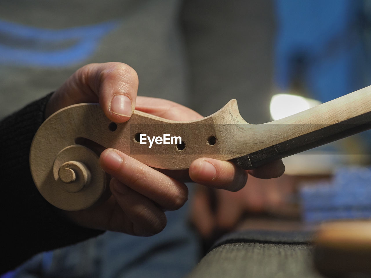 Luthier working a classic violin scroll