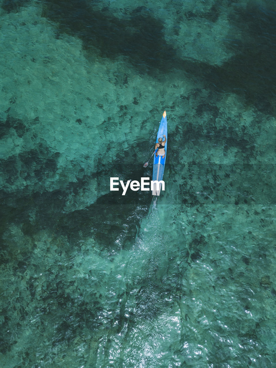 Young woman on stand up paddling board