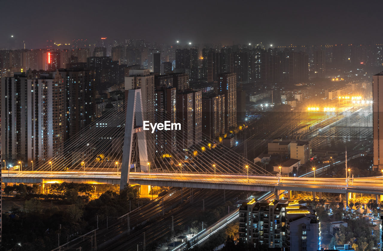 High angle view of illuminated buildings in city at night